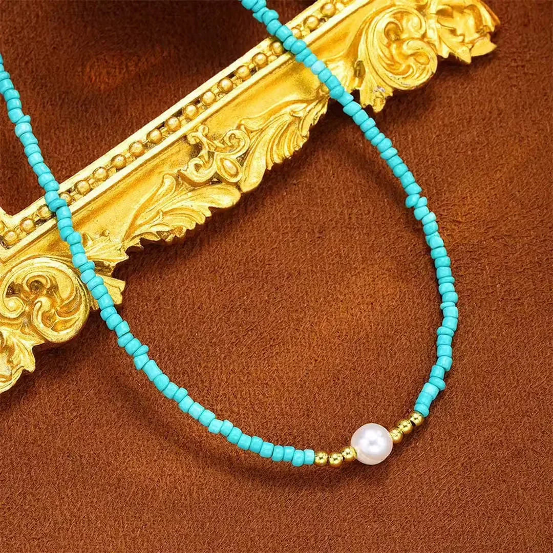 Turquoise beaded necklace with gold baroque filigree accents and white pearl