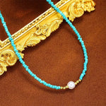 Turquoise beaded necklace with gold baroque filigree accents and white pearl