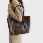 Beige croc-embossed leather tote bag with wide handles and open top