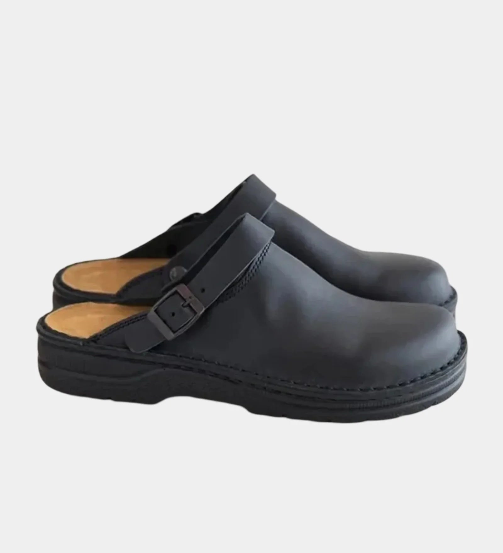 Black clog with adjustable buckle strap and cushioned black rubber sole.