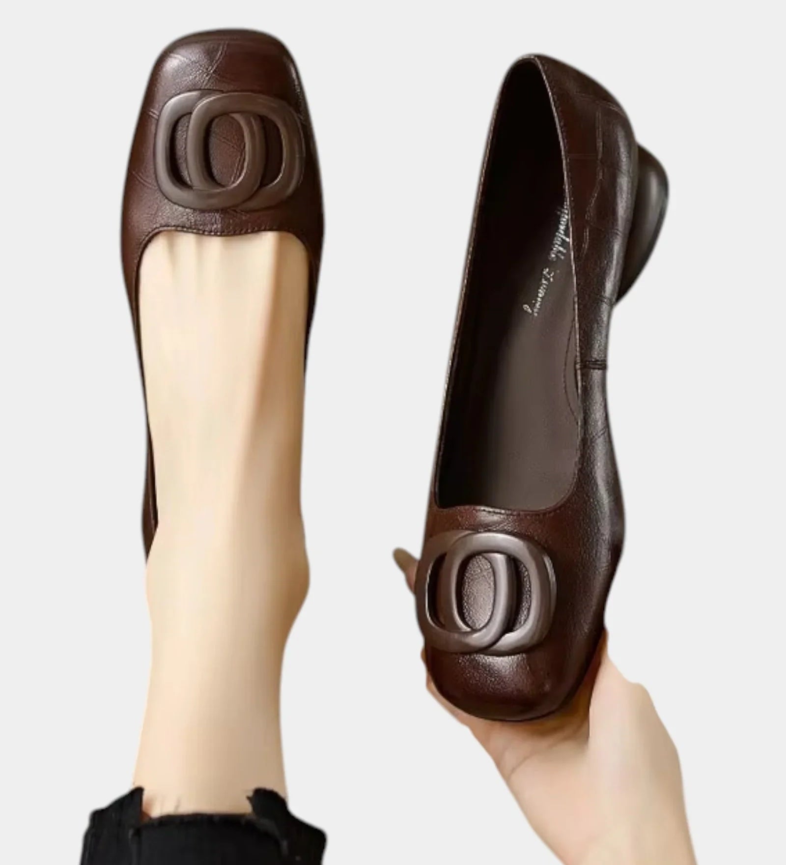 Brown leather loafer slip-on with oval logo hardware detail, low heel