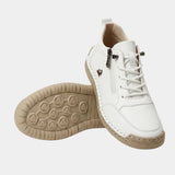 White high-top sneakers with lace-up, side zipper, and textured rubber sole.