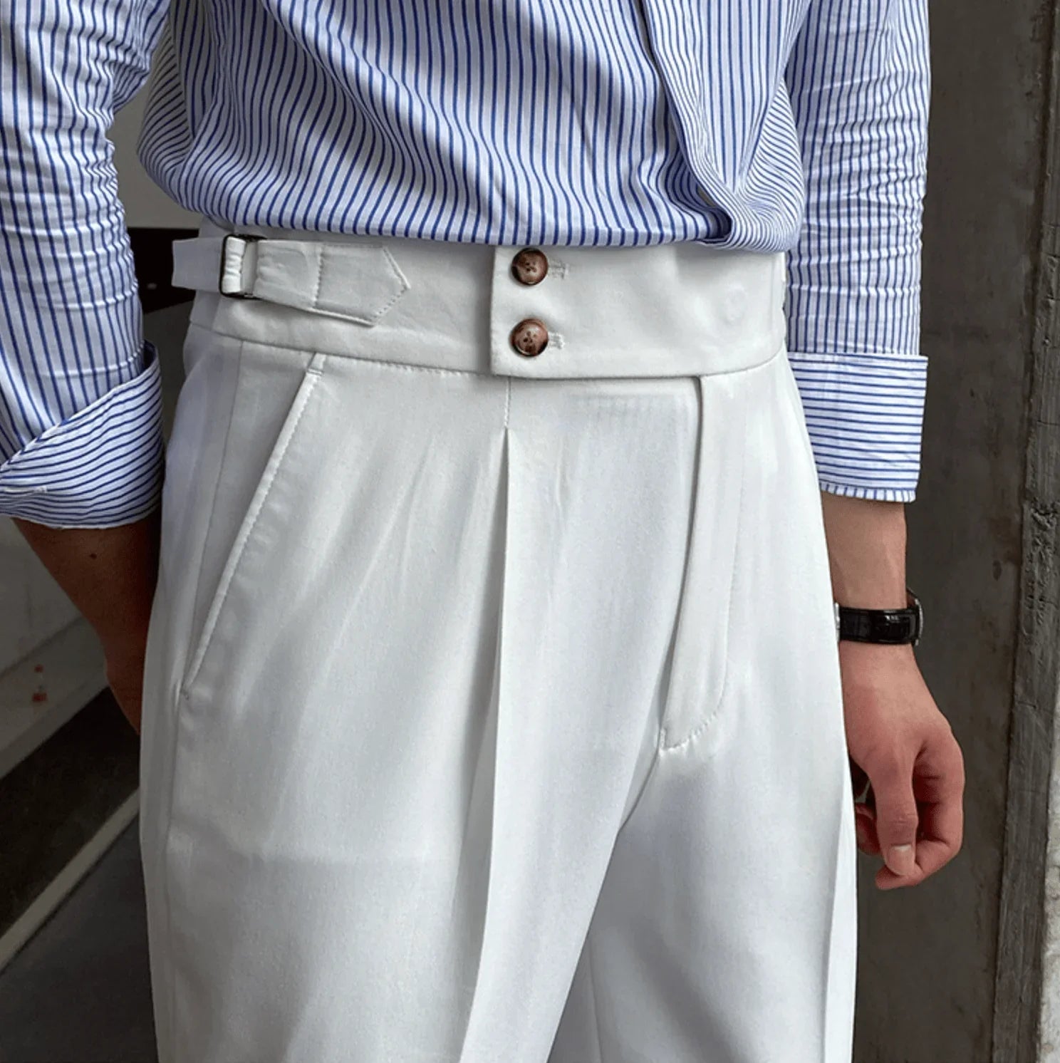 White high-waisted tailored pants with pleated front and double-button waistband