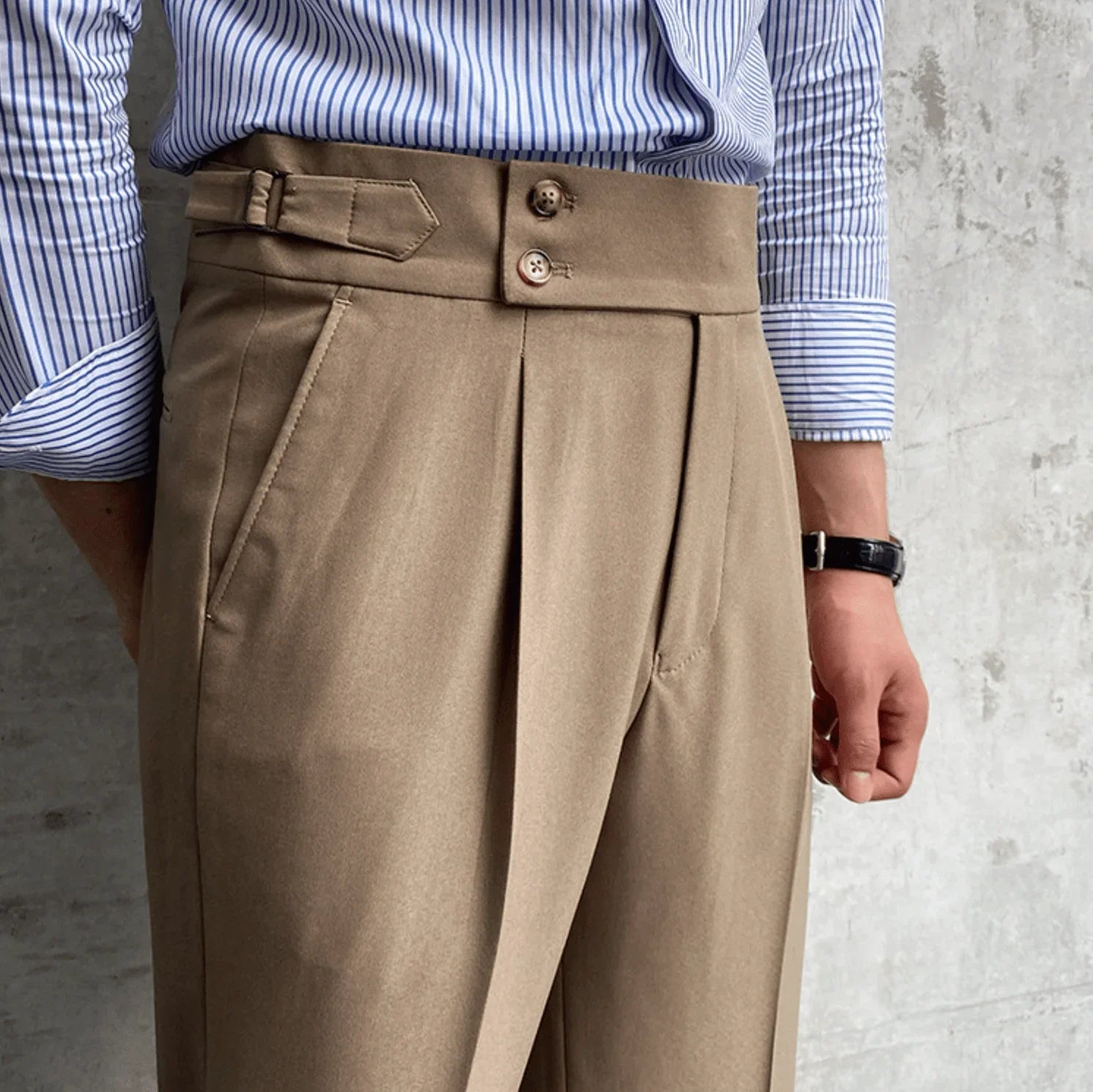Beige high-waisted dress pants with pleated front, belt loops, and button closure