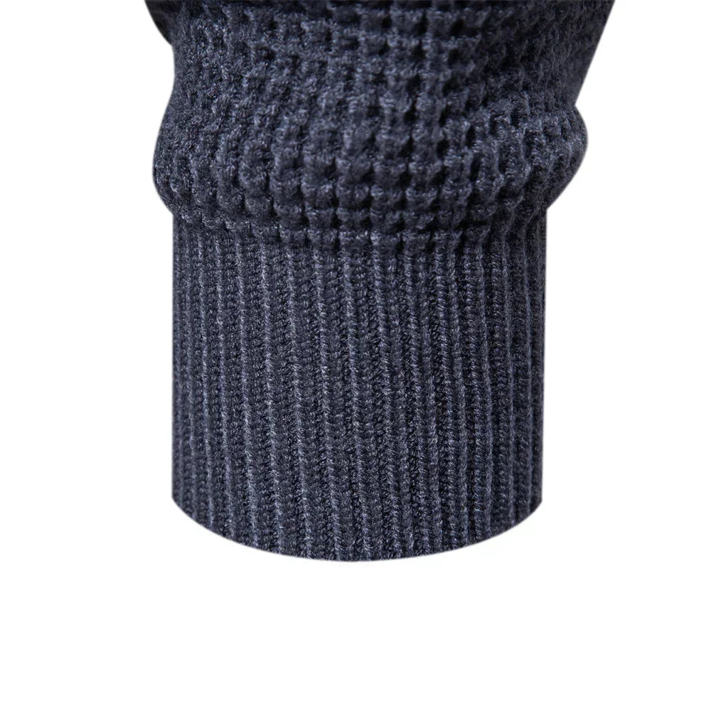 Close-up of dark blue knit sweater hem and cuffs with ribbed texture