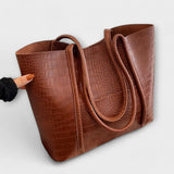 Rust-brown croc-embossed leather tote bag with double handles and open top
