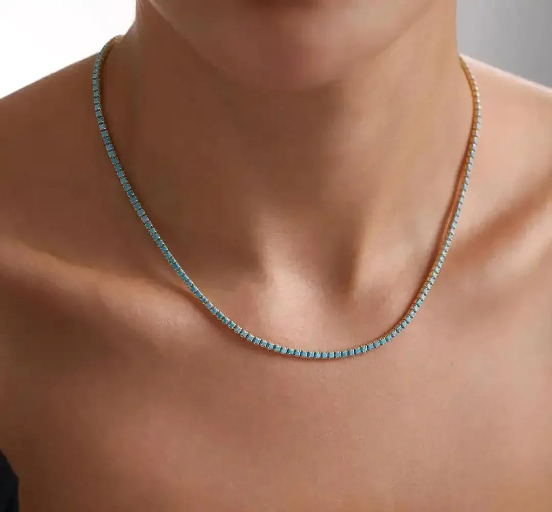 Turquoise stone bead necklace on a gold chain, worn close to neck