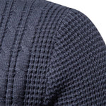 Close-up of dark blue knit sweater texture with vertical cable-like ribbing