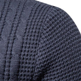 Close-up of dark blue knit sweater texture with vertical cable-like ribbing