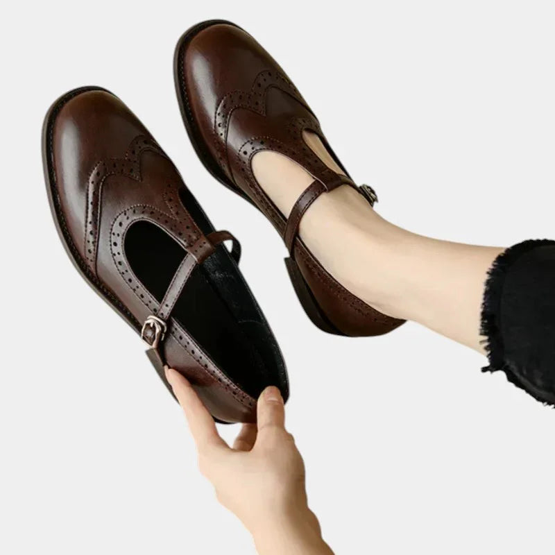 Women's brown T-band dress shoes with brogue detailing and buckle ankle strap