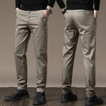 Beige-gray slim chino pants with button closure, belt loops, tapered legs