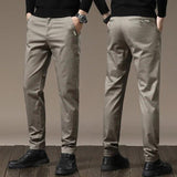 Beige-gray slim chino pants with button closure, belt loops, tapered legs