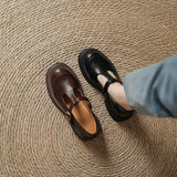 Two leather Mary Jane shoes, brown and black, with buckle T-strap