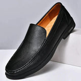 Men's black leather slip-on loafers with metal buckle and dark rubber sole