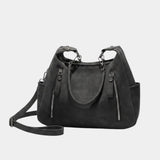 Textured black shoulder bag with curved front and two zip side pockets
