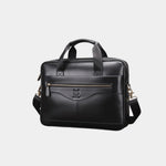 Black leather briefcase with top handle, front zipper pocket, and shoulder strap.