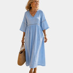 Light blue midi dress with V-neck, short sleeves, embroidered trim, gathered waist