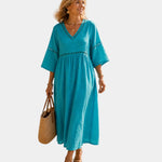 Teal midi dress with V-neck, short sleeves, embroidered trim, gathered waist
