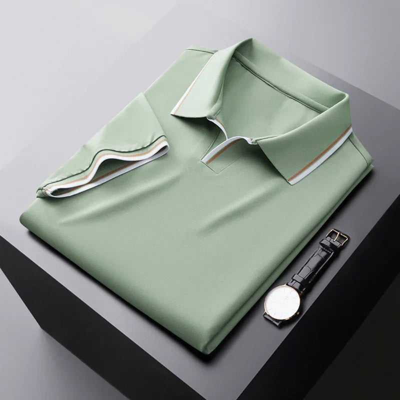 Light green soft silk polo shirt, folded flat with contrast collar trim