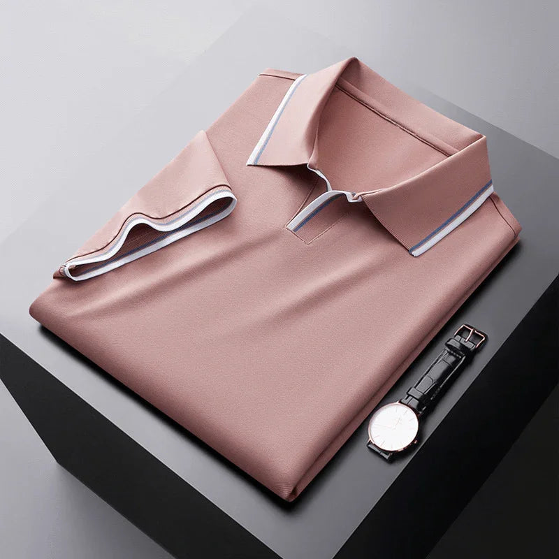Pink soft silk polo shirt, folded flat with contrast collar trim