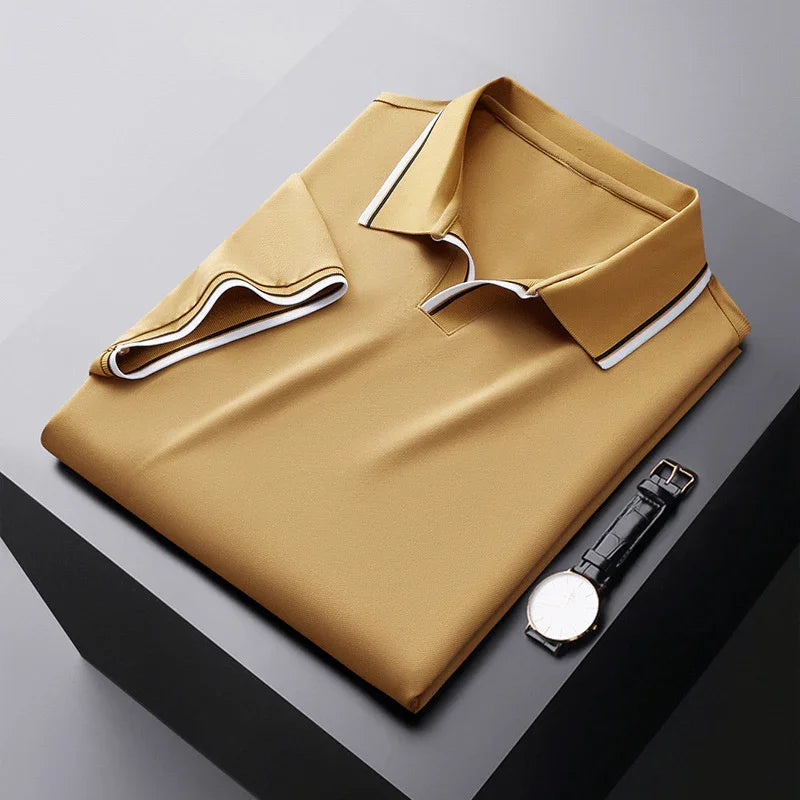 Yellow soft silk polo shirt, folded flat with contrast collar trim