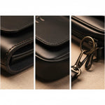 Leather shoulder bag close-up: stitched edges and metal keyring hardware