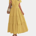 Yellow tiered maxi dress with V-neck, short sleeves, and gathered waist detail