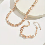Rose gold fish tail link necklace with matching bracelet and chain pieces on display