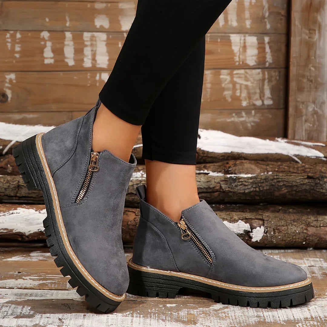 Gray suede ankle orthopedic boots with gold-tone side zipper and lug sole