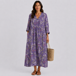 Purple floral midi dress with V-neck, three-quarter sleeves, and gathered waist