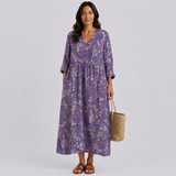 Purple floral midi dress with V-neck, three-quarter sleeves, and gathered waist