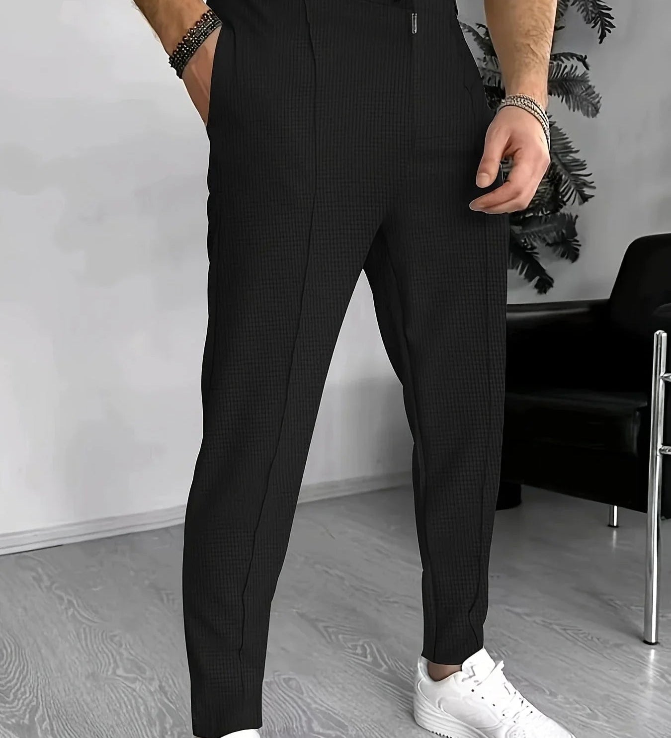 Black checkered jogger pants with elastic waistband and drawstring, tapered legs