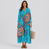 Women's teal V-neck summer dress with colorful abstract print and 3/4 sleeves