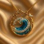 Gold ocean wave pendant necklace with circular bezel, blue swirl enamel, rhinestone detail