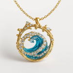Gold ocean wave pendant necklace with blue enamel swirl, ornate frame and clear stones
