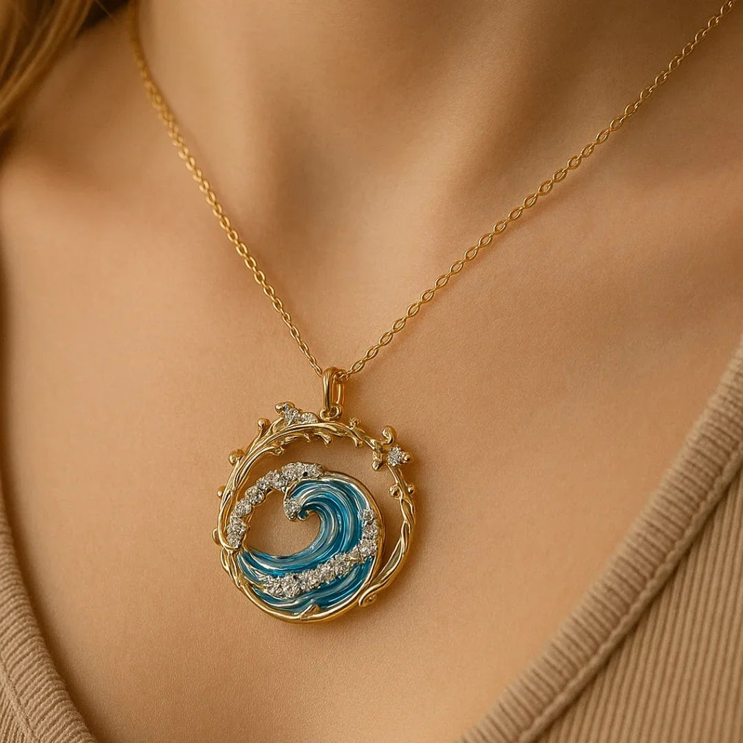 Gold ocean wave pendant necklace with blue swirl enamel and diamond-like stones