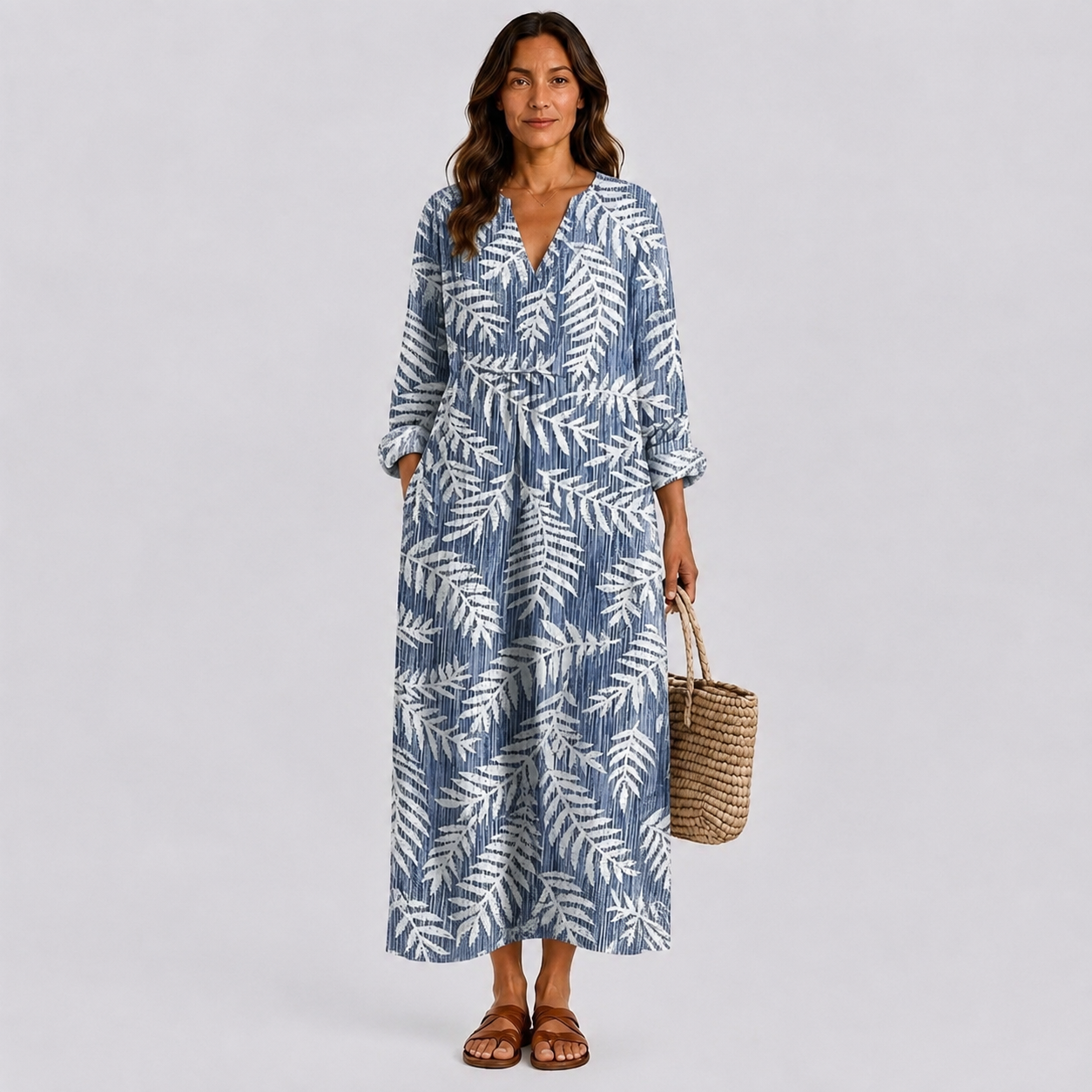 Blue and white patterned midi dress with V-neck, long sleeves, and tie waist