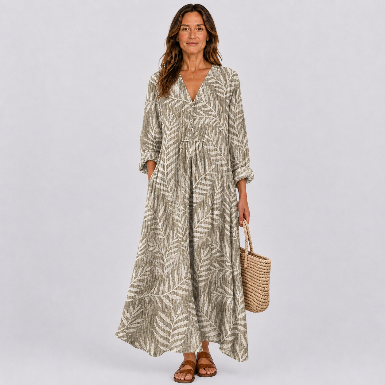 Leaf-pattern summer dress with V-neck, gathered waist, long sleeves, tiered skirt.