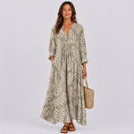 Leaf-pattern summer dress with V-neck, gathered waist, long sleeves, tiered skirt.