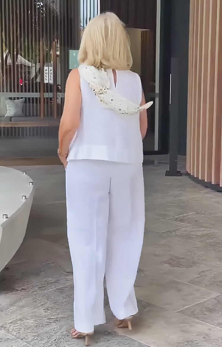 White back view sleeveless top and wide-leg pants with embellished scarf