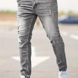 Slim-fit ripped jeans in light gray wash, distressed knees and fitted taper