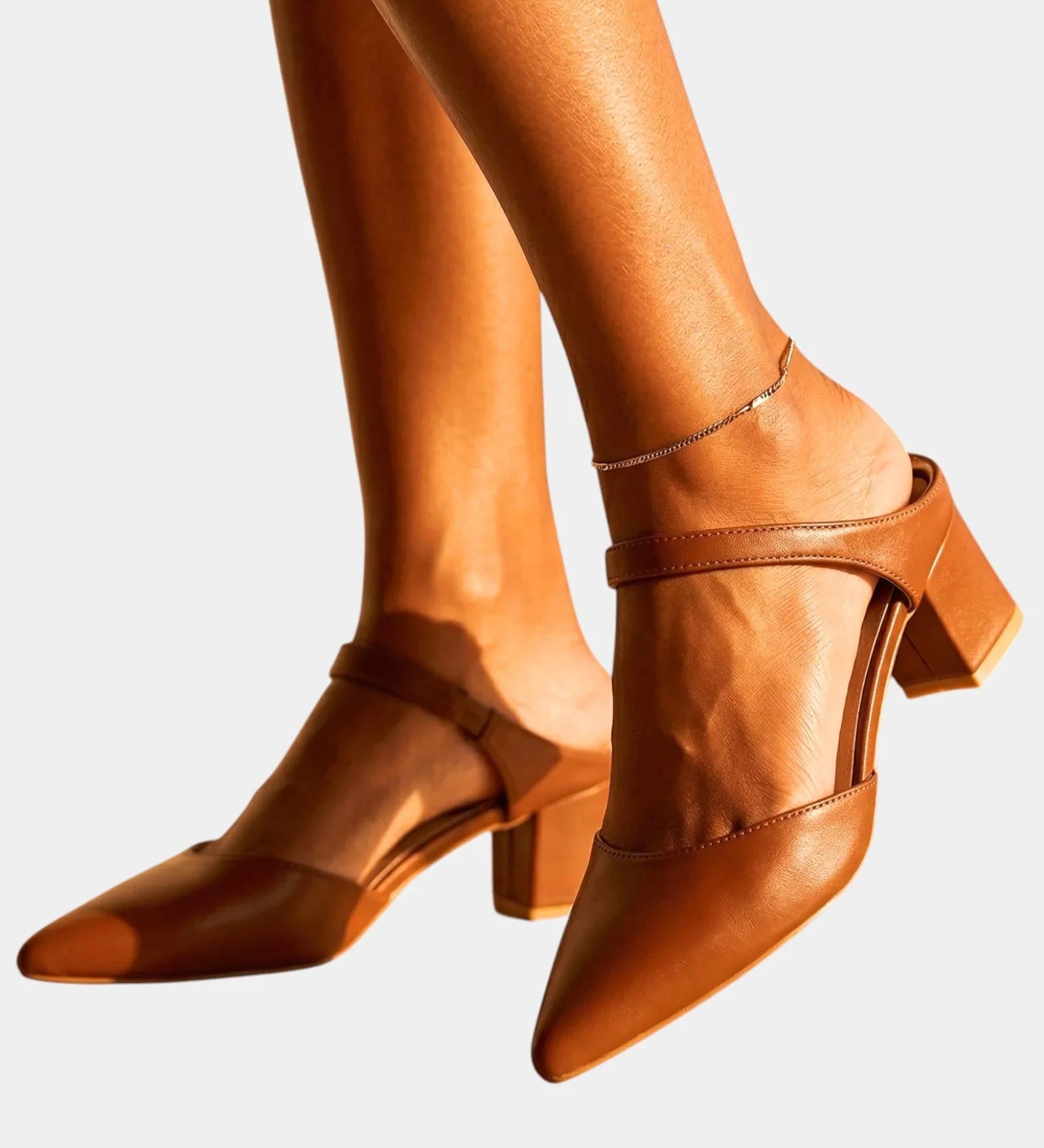 Brown back-strap heels with ankle strap, buckle, and block heel