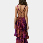Back view of purple and rust abstract print tiered maxi dress with strappy open back
