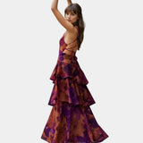 Purple and rust abstract print tiered maxi dress, side view with flounced hem