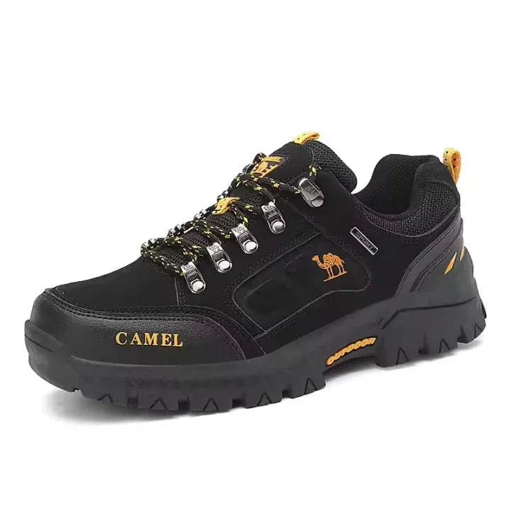 Black mountain boots with yellow laces and orange logo, lace-up, chunky tread outsole