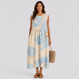 Sleeveless maxi summer dress in light beige with blue floral pattern