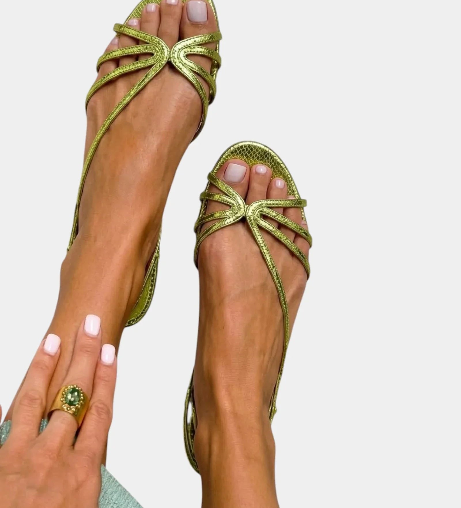 Green strappy sandals with jeweled starburst bow and open toe.