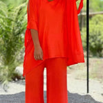 Orange V-neck tunic with draped sleeves and wide-leg pants set