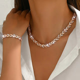 Rose gold fish tail link necklace with matching bracelet on the wrist