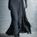 Charcoal gray draped maxi dress close-up with ruched knot and layered skirt folds